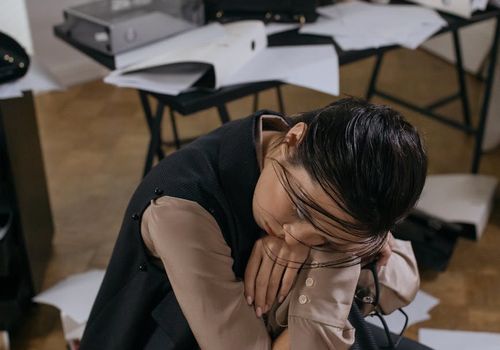 Person working at office desk looking tired